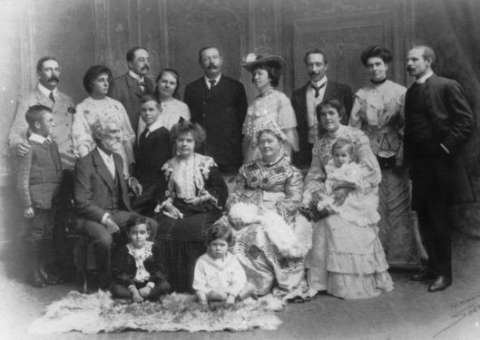 1904: Standing from left to right: Innes with young Arthur Oscar Hornung, Constance Doyle (Connie), Ernest W. Hornung, Mary and Kingsley, Arthur Conan Doyle, Caroline Doyle (Lottie) and Leslie Oldham, Bryan Mary Doyle (Dodo) and Cyril Angell. Seated from left to right: Nelson Foley, Louisa Conan Doyle, Mary Doyle (The Ma'am), Ida Foley with Innes Foley. Seated on floor: Percy Foley and Branford Angell.