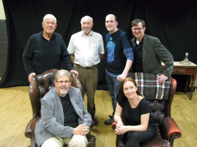 From left to right: Geoff Sword (old Watson), Bob Howell (old Holmes), Chris Dunn (young Holmes), Chris Balmer (young Watson). Seated: Bert Coules (playwright), Elizabeth Dunn (director).