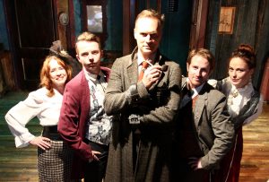 From left to right: Mrs. Hudson (Patricia Hammond), Sir Henry Baskerville (T. J. Little), Sherlock Holmes (J. Richey Nash), Dr. Watson (Liam McDermott) and Miss Stapleton (Erika S. Lee).