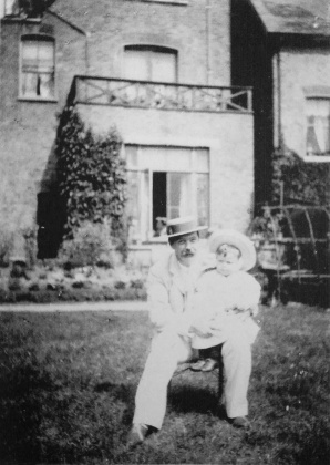 Kingsley in the arms of his father at 12 Tennison Road (1894).