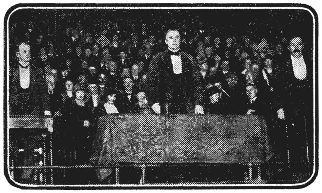The scene at Queen's Hall during the debate on "The Truth os Spiritualism." Sir Edward Marshall Hall, K.C. (centre), presided, while Sir Arthur Conan Doyle (right) defended the cause against the vigorous attack of Mr. Joseph McCabe (left).