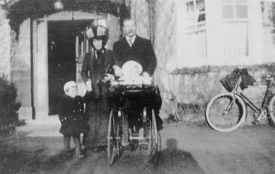 Arthur Conan Doyle and his wife. His bicycle in background (1910).
