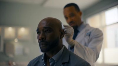 Dr. Marcus, behind (Kareem Malcolm)