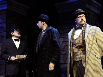 Ticket Seller (Conor Woods) , Sherlock Holmes (William Elsman) and Dr. Watson (Michael R. J. Campbell)
