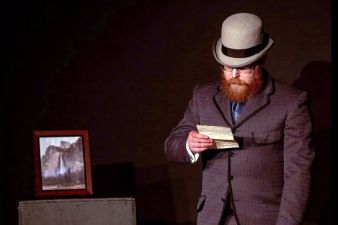 Dr. Watson (Paul Sutherland) reading the note left by Sherlock Holmes.