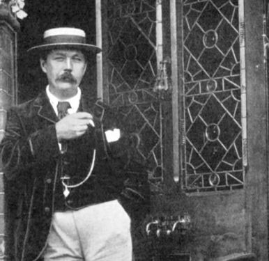 Arthur Conan Doyle smoking cigarette at the door of his house at 12 Tennison Road (1894).