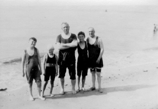 Arthur Conan Doyle with children and Major Alfred H. Wood in bathing suits.