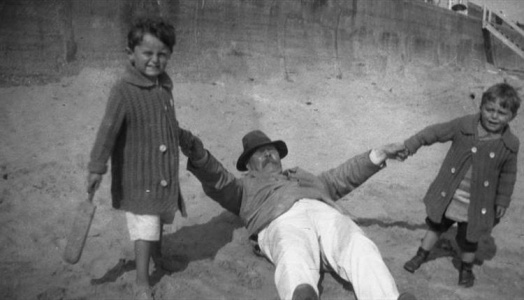Adrian (left) at Frinton-on-Sea pulling his father with his brother Denis (1913)