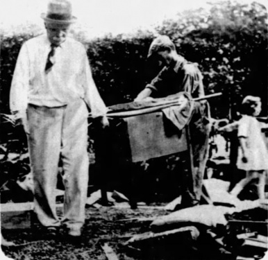 Arthur Conan Doyle salvaging effects in the wake of the fire that partly destroyed his home, Bignell Wood (15 august 1929).